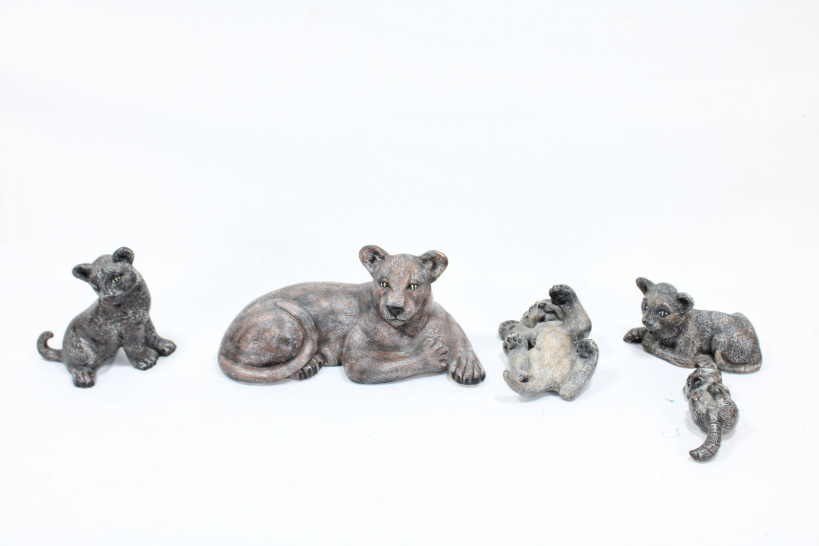 Decorative Lion Family Sculpture Set: This beautifully detailed set includes a lioness and her playful cubs, captured in various naturalistic poses. Each piece is crafted with textured finishes, offering a lifelike depiction of these maje