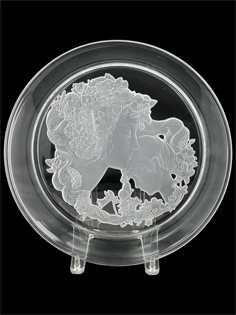 Luciana Roselli Mother and Child Crystal Art Plate: A stunning etched crystal plate by Luciana Roselli featuring the delicate image of a mother and child surrounded by floral motifs. This artful piece measures 12 1/2" in diameter and showcases intricat