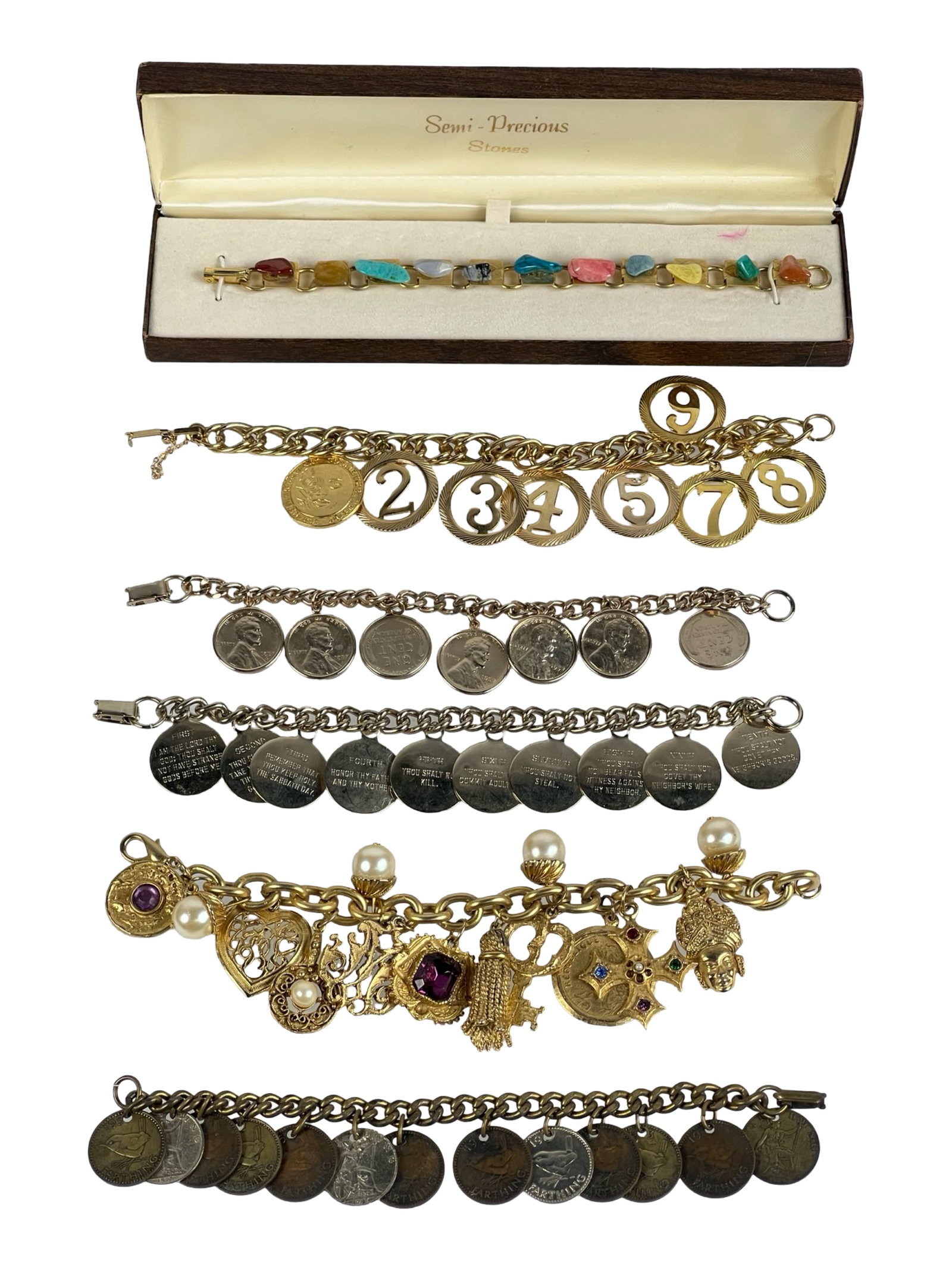 Assortment of Vintage Charm and Coin Bracelets: A collection of vintage charm and coin bracelets