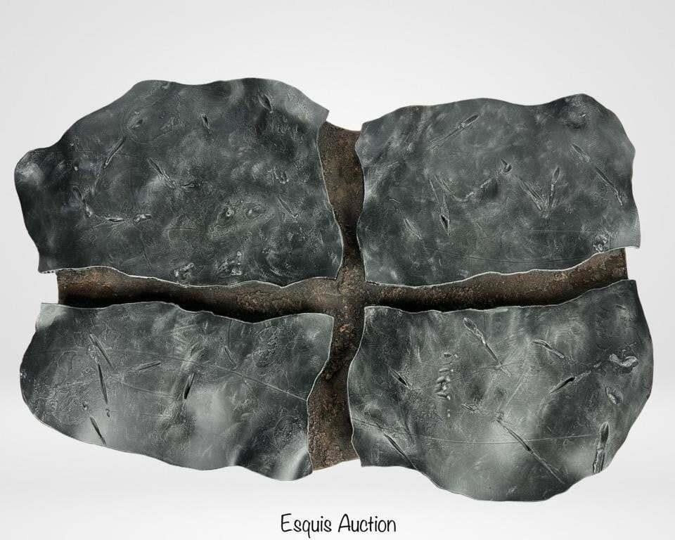 Abstract Metal Wall Sculpture: This captivating abstract metal wall sculpture features a unique and textured design. Composed of four irregularly shaped sections, the piece has a rugged, organic appearance with a metallic finish th