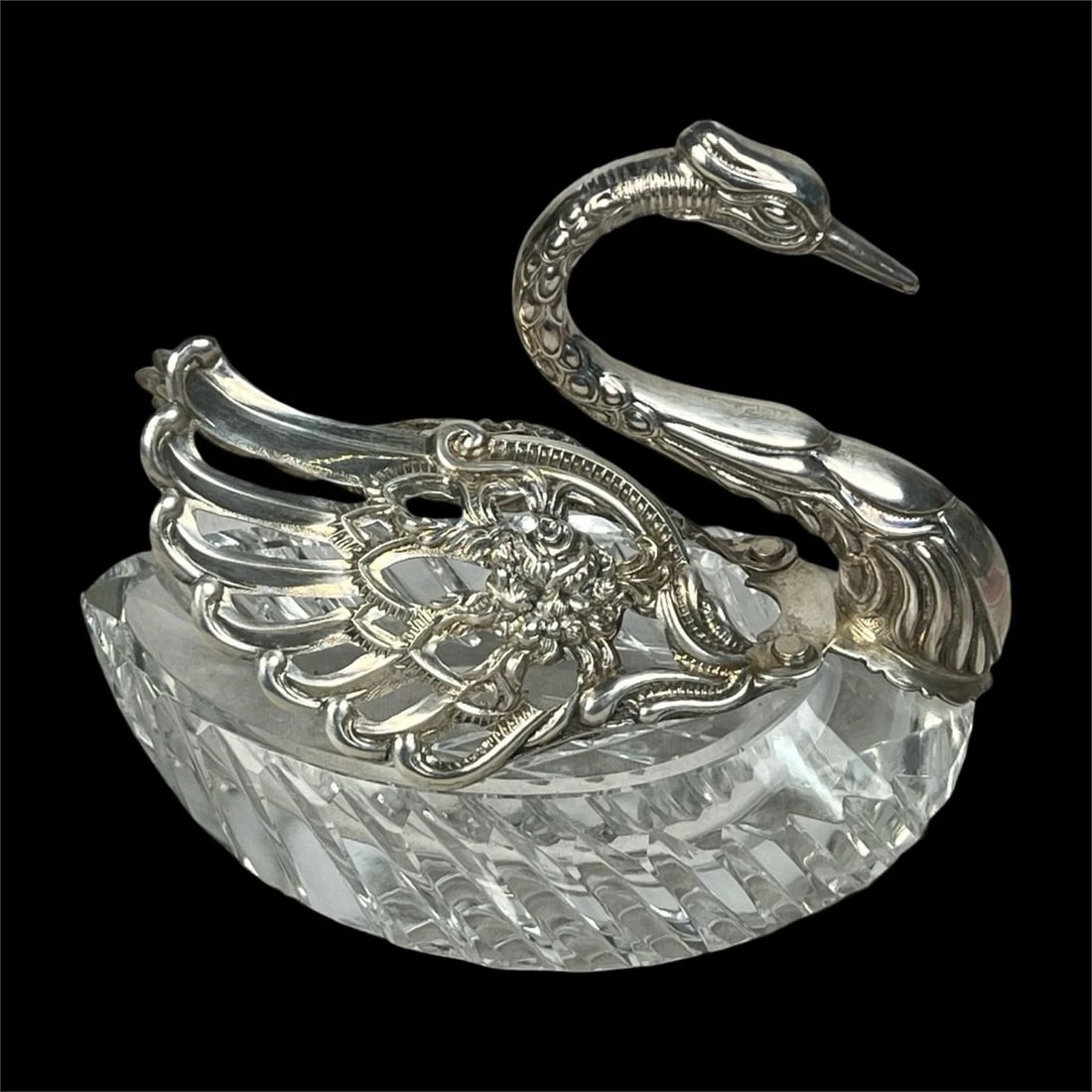 Sterling Silver Cut Crystal Swan Salt Cellar: This elegant sterling silver and cut crystal salt cellar is crafted in the shape of a swan, featuring intricately detailed wings and a beautifully faceted crystal body. Measuring 5" x 5" x 3", this pi