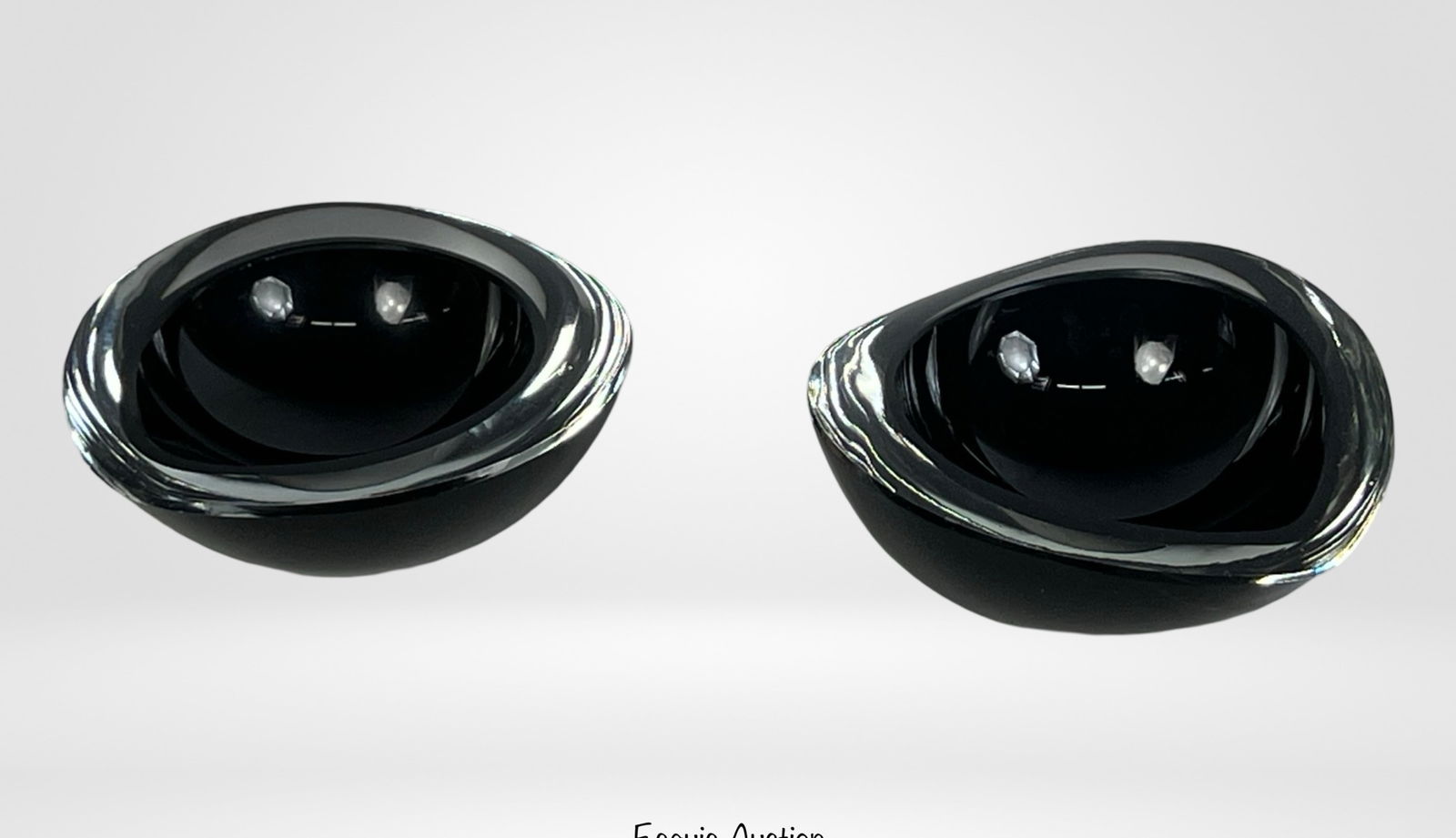 Kaj Franck for Nuutajarvi Chestnut Art Glass Bowls: A pair of signed Kaj Franck art glass bowls for NuutajÃ¤rvi, designed in a striking chestnut shape. Crafted from sleek black glass with a clear, polished rim, these minimalist bowls reflect Franck's