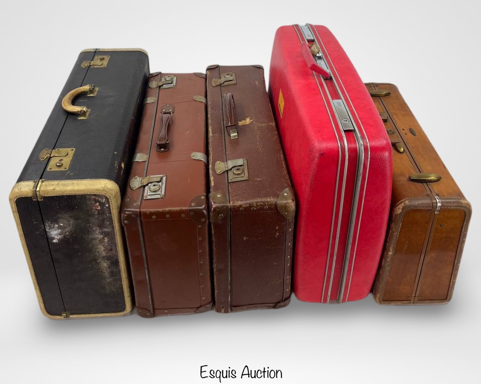 Vintage 1950s-1970s Suitcase Luggage Set: A collection of vintage luggage from the 1950s-1970s, featuring a variety of styles, materials, and sizes. This set includes six suitcases, each showcasing unique details such as metal corner reinforc