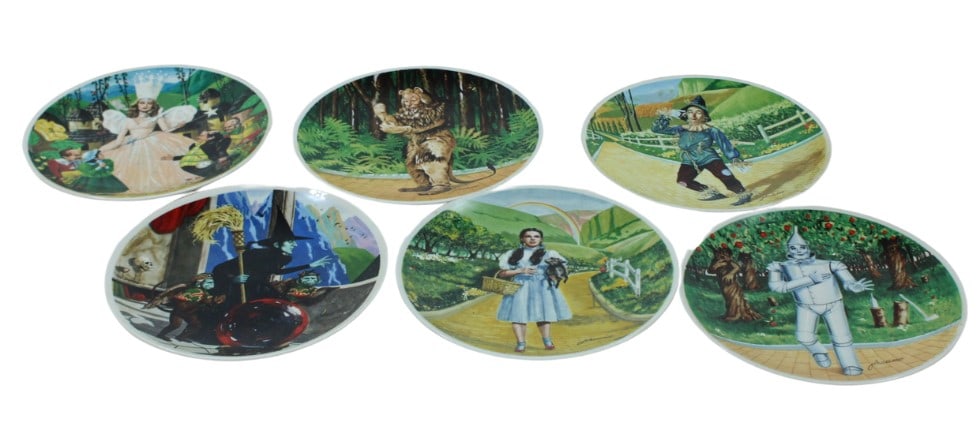 The Wizard of Oz Collector's Porcelain Plate Set: Set of six beautifully illustrated The Wizard of Oz collector's plates, each depicting iconic scenes from the classic film. Plates feature beloved characters including Dorothy, the Tin Man, Scarecrow,