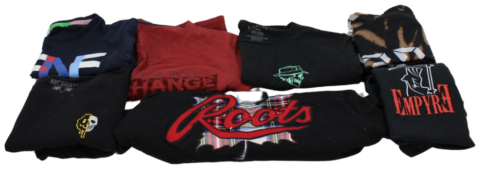 Designer and Graphic T-Shirts- Armani, Benetton, Roots: Group of quality branded and graphic t-shirts including popular names like Benetton and Armani Exchange. Some pieces feature unique graphic designs, including "Roots" and "Empyre" styles. Sizes vary f