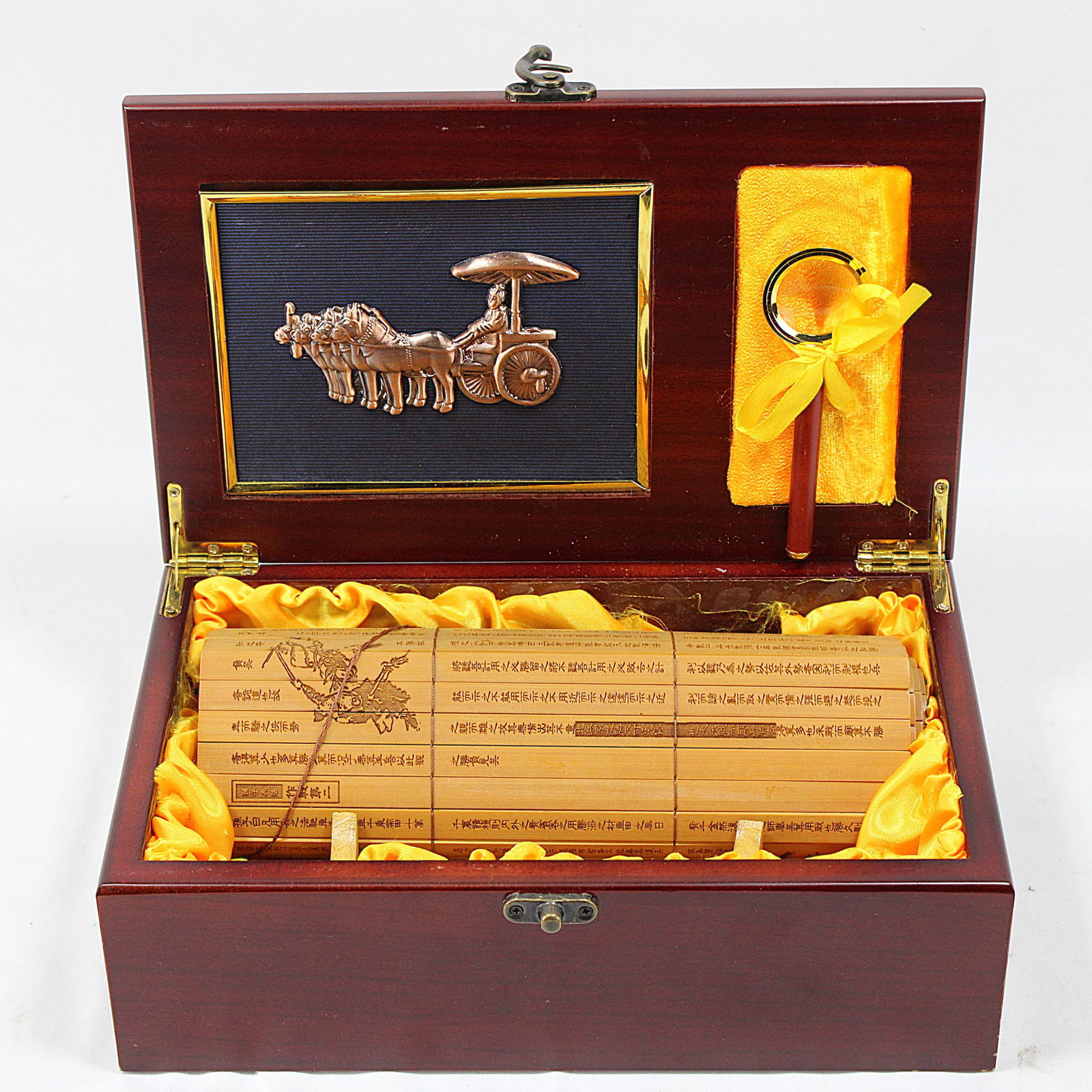 Chinese Wooden Presentation Box with Bamboo Scroll: Luxurious wooden presentation box featuring a brass-embossed design of a horse-drawn carriage on the lid. Inside, a beautifully engraved bamboo scroll rests on a satin-lined interior alongside a keych