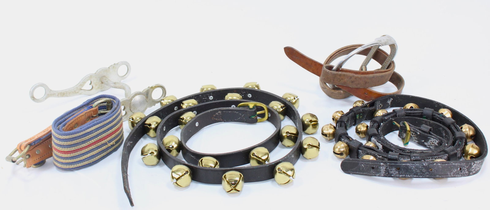 Vintage Horse Tack - Sleigh Bells, Spur, Straps...: and gun emo belt, revolver holders. Assorted vintage horse tack, featuring a collection of leather sleigh bell straps adorned with brass bells, a metal spur, and leather straps. The sleigh bells produ