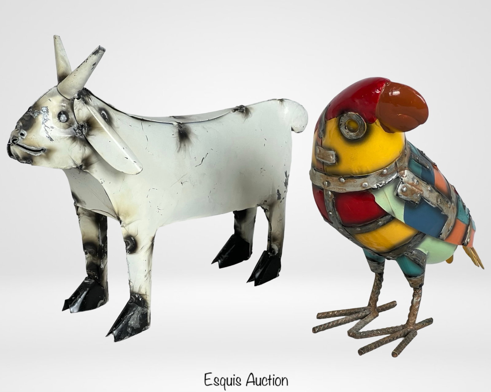 Rustic Metal Parrot and Goat Sculptures: A charming pair of handcrafted metal sculptures featuring a rustic-style goat and a vibrantly colored parrot. The goat sculpture is made of welded metal panels with a weathered, burnished finish, givi