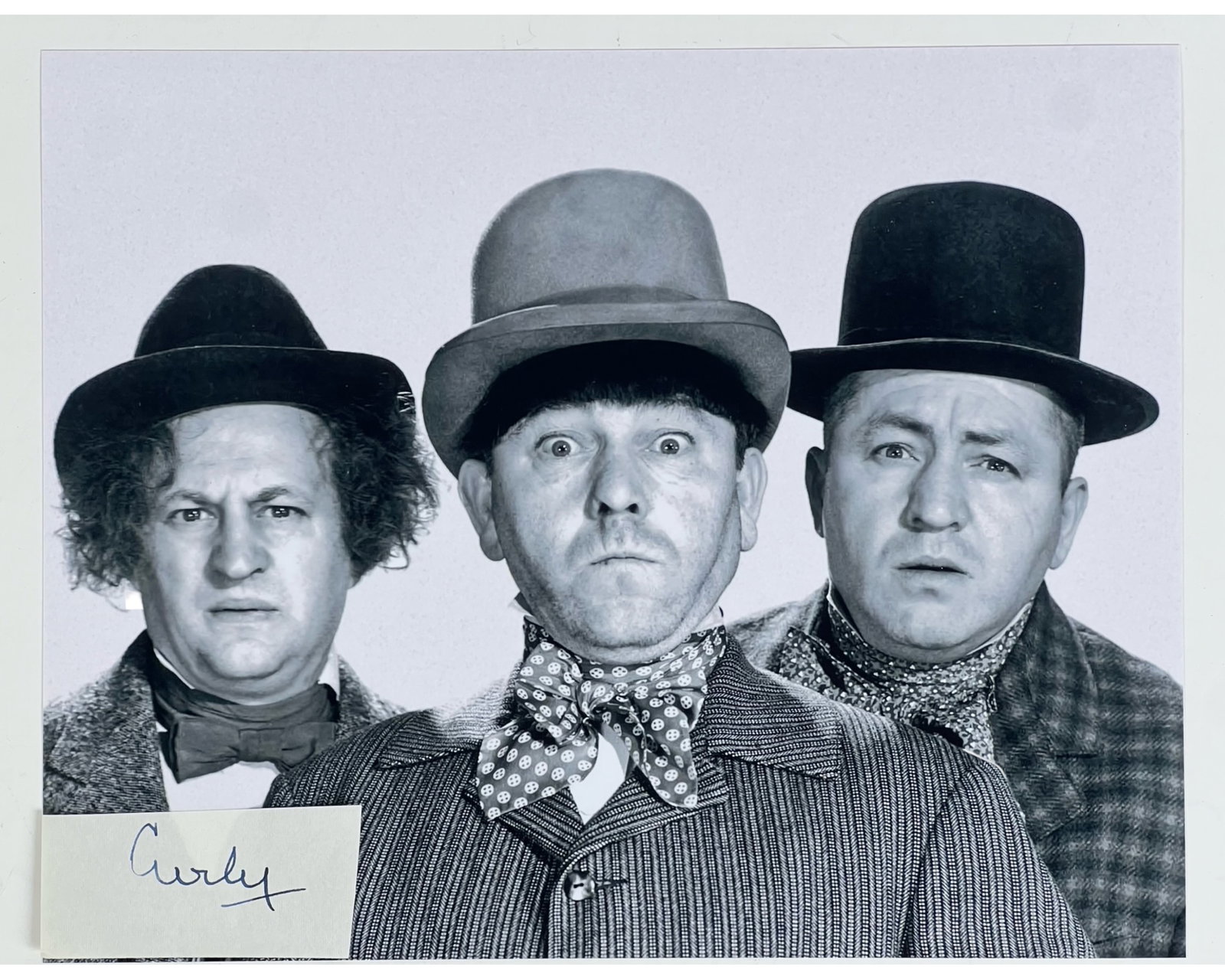 Curly "Stooge" Howard Signature w/ 3 Stooges Photo: Curly Howard Signature Cut, a truly exceptional and rare piece of memorabilia from one of the most iconic members of the classic comedy trio, The Three Stooges. Comes with 8" x 10" "3 Stooges" Photogr