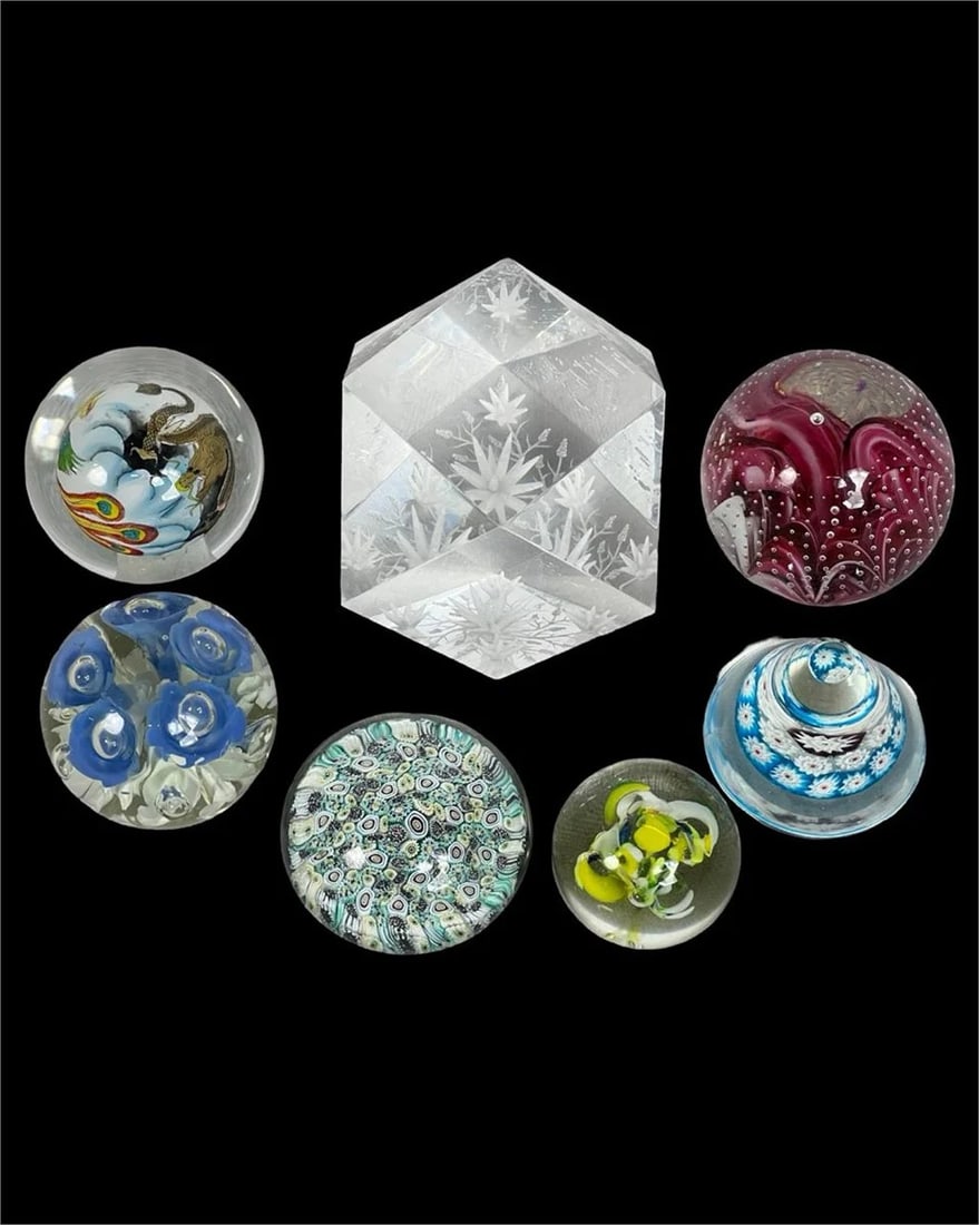Collection of Vintage Art Glass Paperweights: This curated collection includes seven unique vintage glass paperweights, each showcasing a distinct artistic technique and design. Highlights of the collection include: A vibrant Millefiori paperweig