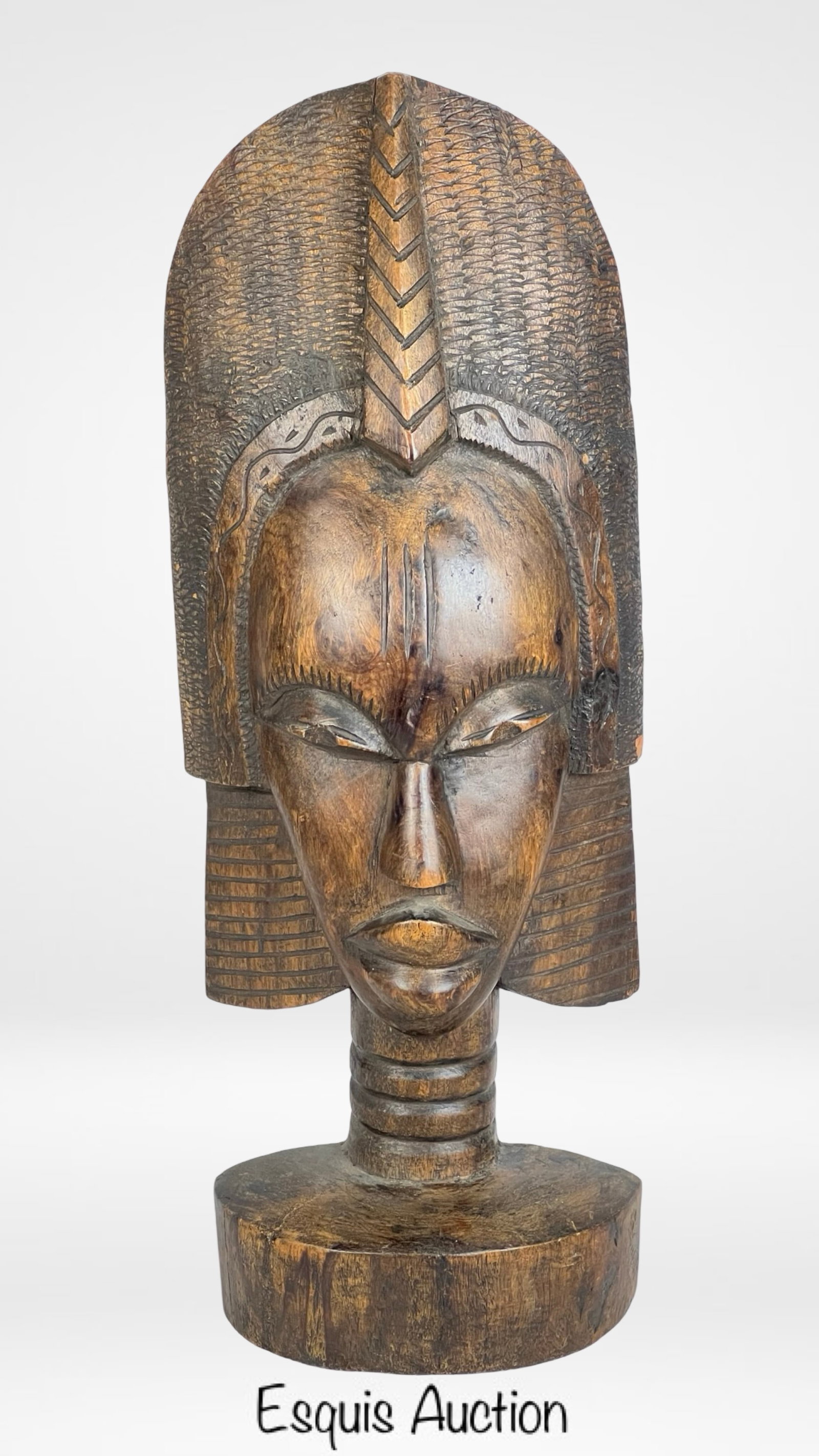 Vintage African Hand-Carved Wooden Female Bust: Beautifully hand-carved wooden female bust, most likely originating from Kenya, dating back to the 1950s-1960s. This striking sculpture features intricate detailing, including a tall, textured headdre