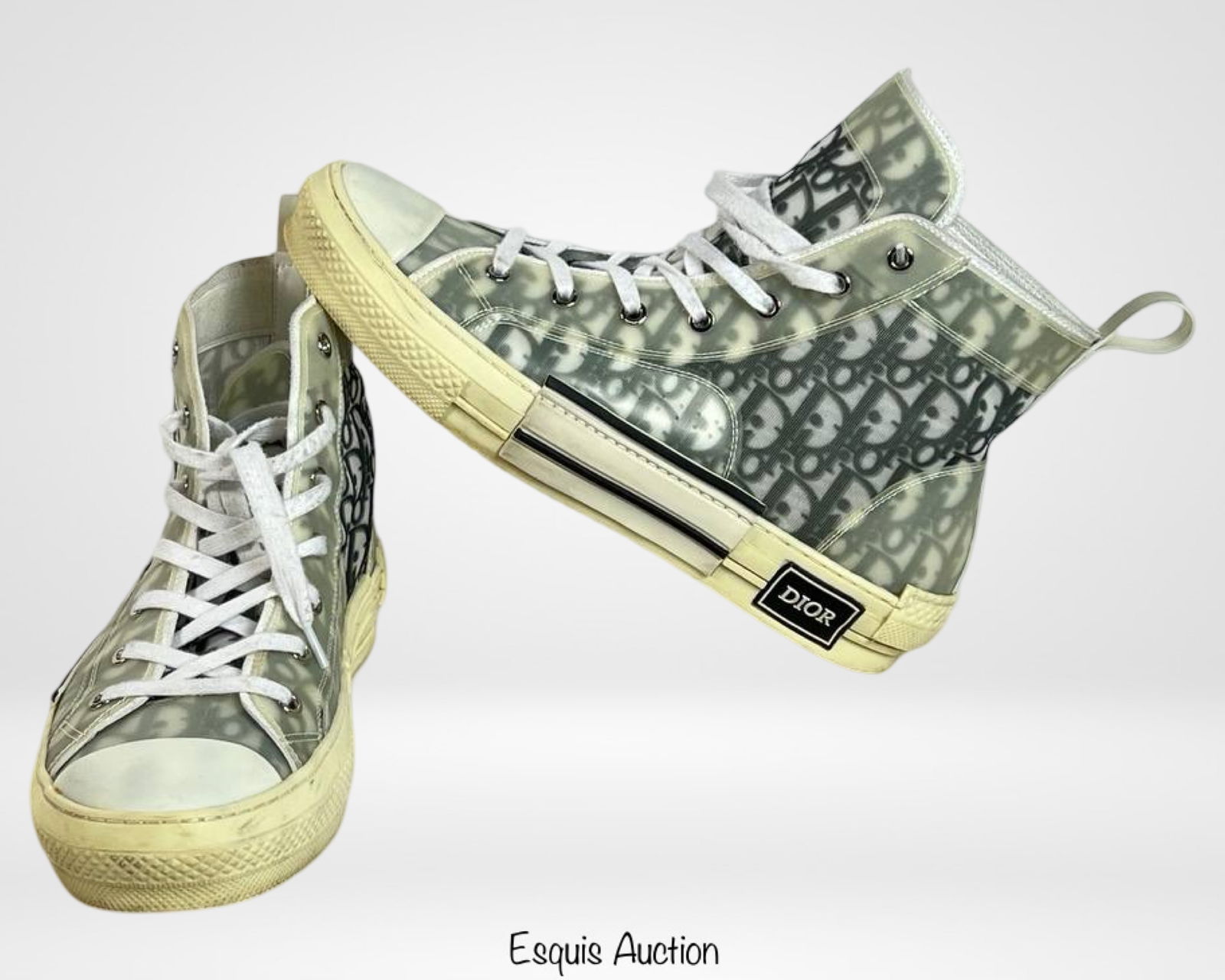 Dior B23 High 'Dior Oblique' Sneakers - Size 44: Luxury meets streetwear in these Dior B23 High 'Dior Oblique' Sneakers, featuring the iconic Dior monogram pattern in a sleek, translucent design. These high-top sneakers blend classic elegance with c