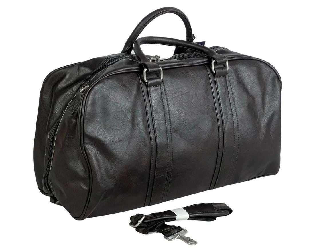 Ben Sherman Travel Weekender Carry-On Duffel Bag: Ben Sherman Weekender Duffel Bag in black vegan leather. Spacious and stylish with dual top handles, a detachable shoulder strap, and a fully lined interior. Measures 29" x 7.5" x 12.5", making it per