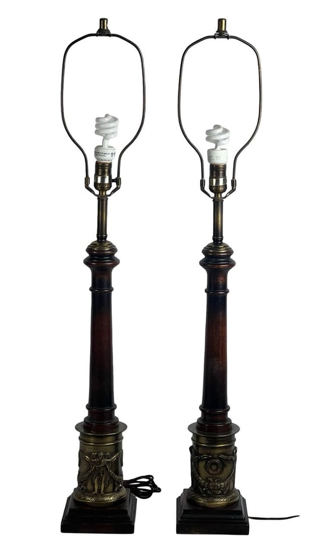 Frederick Cooper Neoclassical Column Table Lamps: Pair of Frederick Cooper Chicago table lamps featuring tall wooden columns on decorative metal bases with figural neoclassical reliefs including winged victories, laurel wreaths, and draped garlands.
