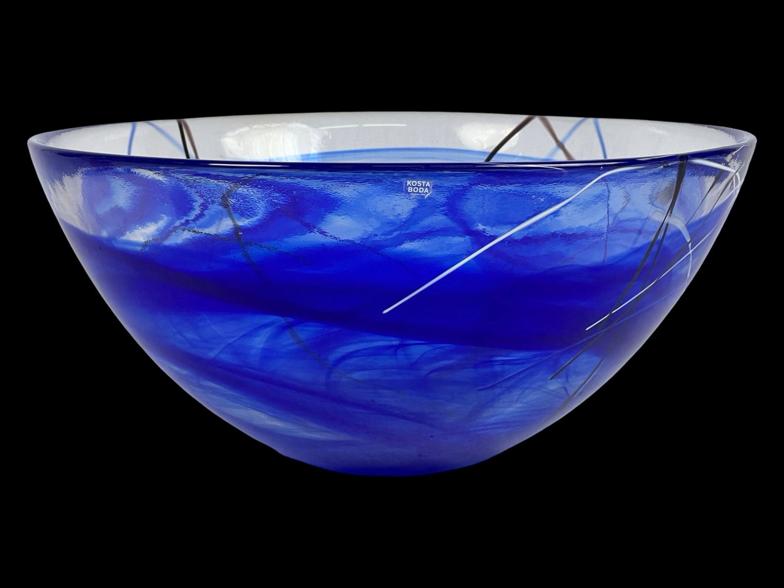 Kosta Boda "Contrast" Large Blue Art Glass Bowl: Striking art glass centerpiece bowl from the "Contrast" series by Anna Ehrner for Kosta Boda, Sweden. This large-format bowl is crafted using a special centrifuging technique that creates swirling vei
