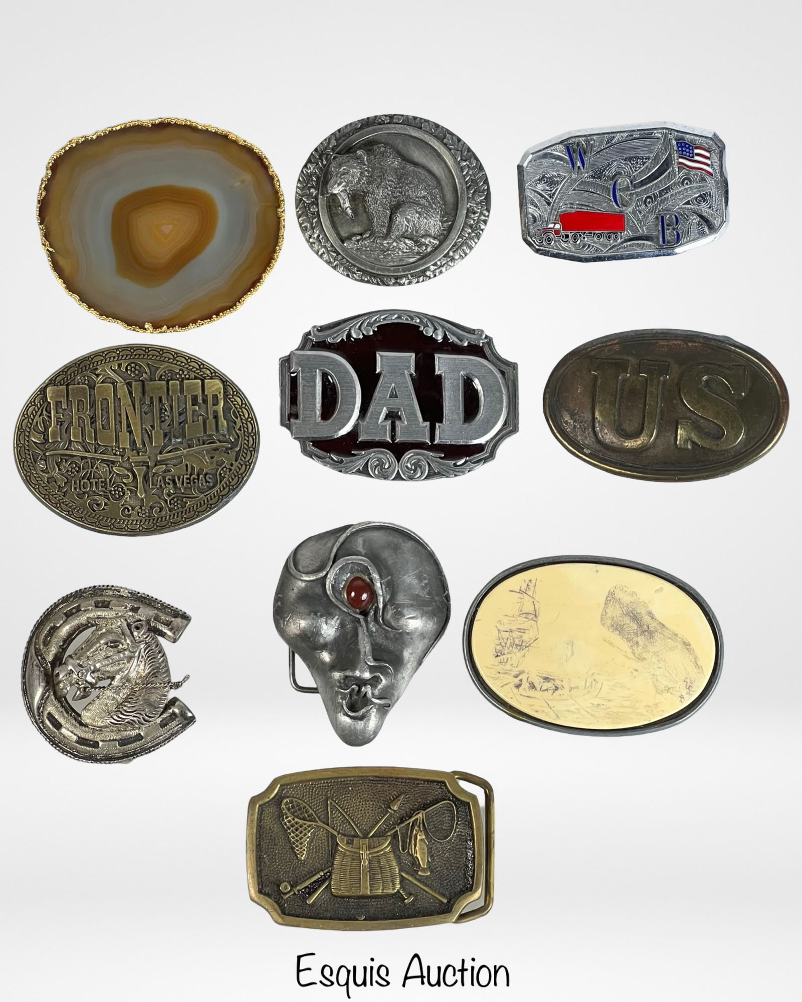 Assortment of Vintage Belt Buckles: Group of 10 vintage and novelty belt buckles. Includes pewter bear buckle by Indiana Metal Craft, enamel "DAD" buckle, brass "FRONTIER Hotel Las Vegas" buckle, trucking-themed enamel buckle by Bergamo