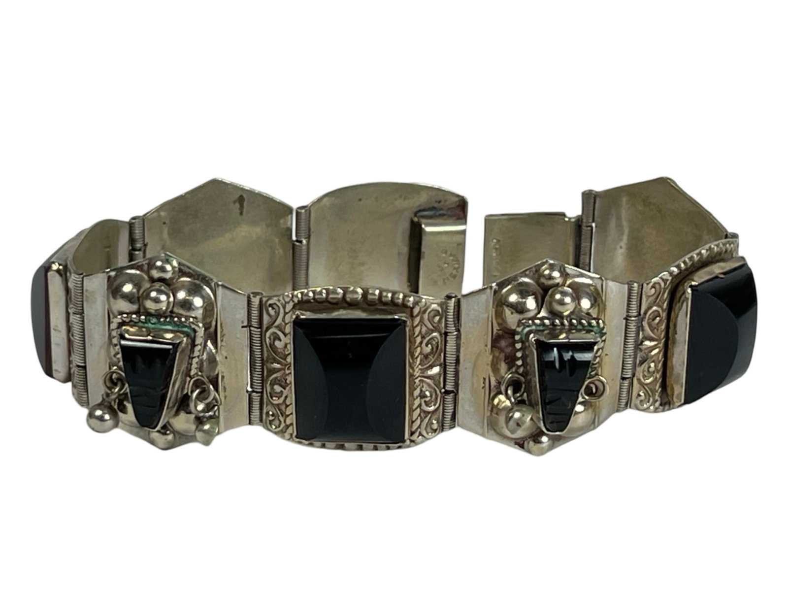 Mexican Bracelet with Carved Black Onyx Faces: Mexican Bracelet with Carved Black Onyx Aztec/ Mayan Faces. 7 1/2" x 1 1/4".