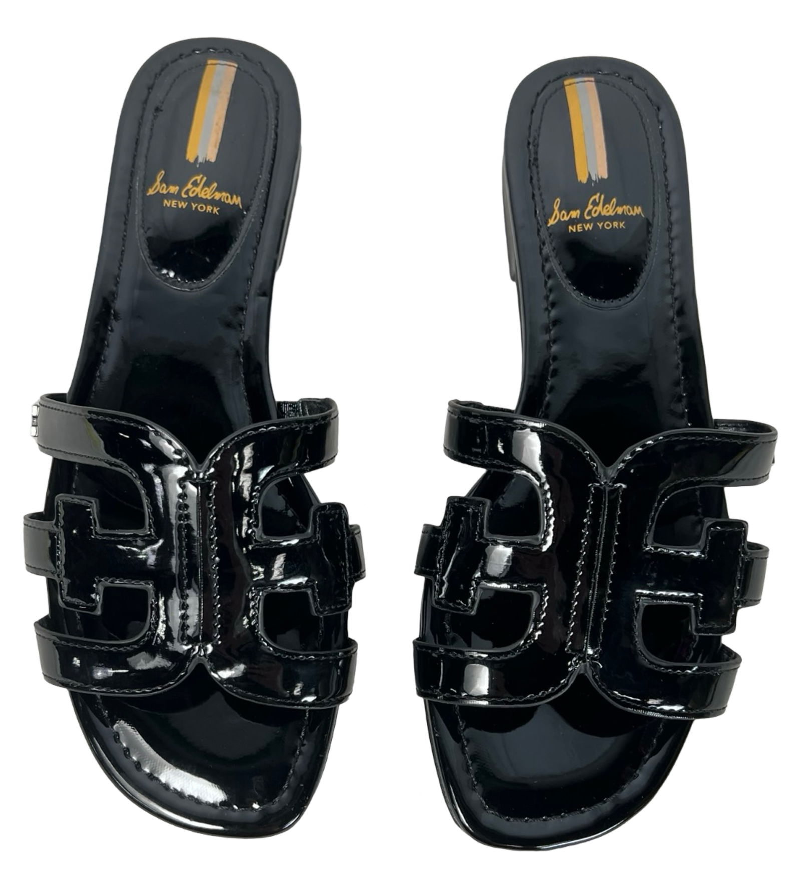 Sam Edelman Leather Bay Cutout Slide Sandals: Pair of Sam Edelman designer Bay slide sandals in glossy black patent leather featuring signature interlocking cutout design, low heel, and lightly cushioned footbed. Marked size 8.5. Rubber soles wit