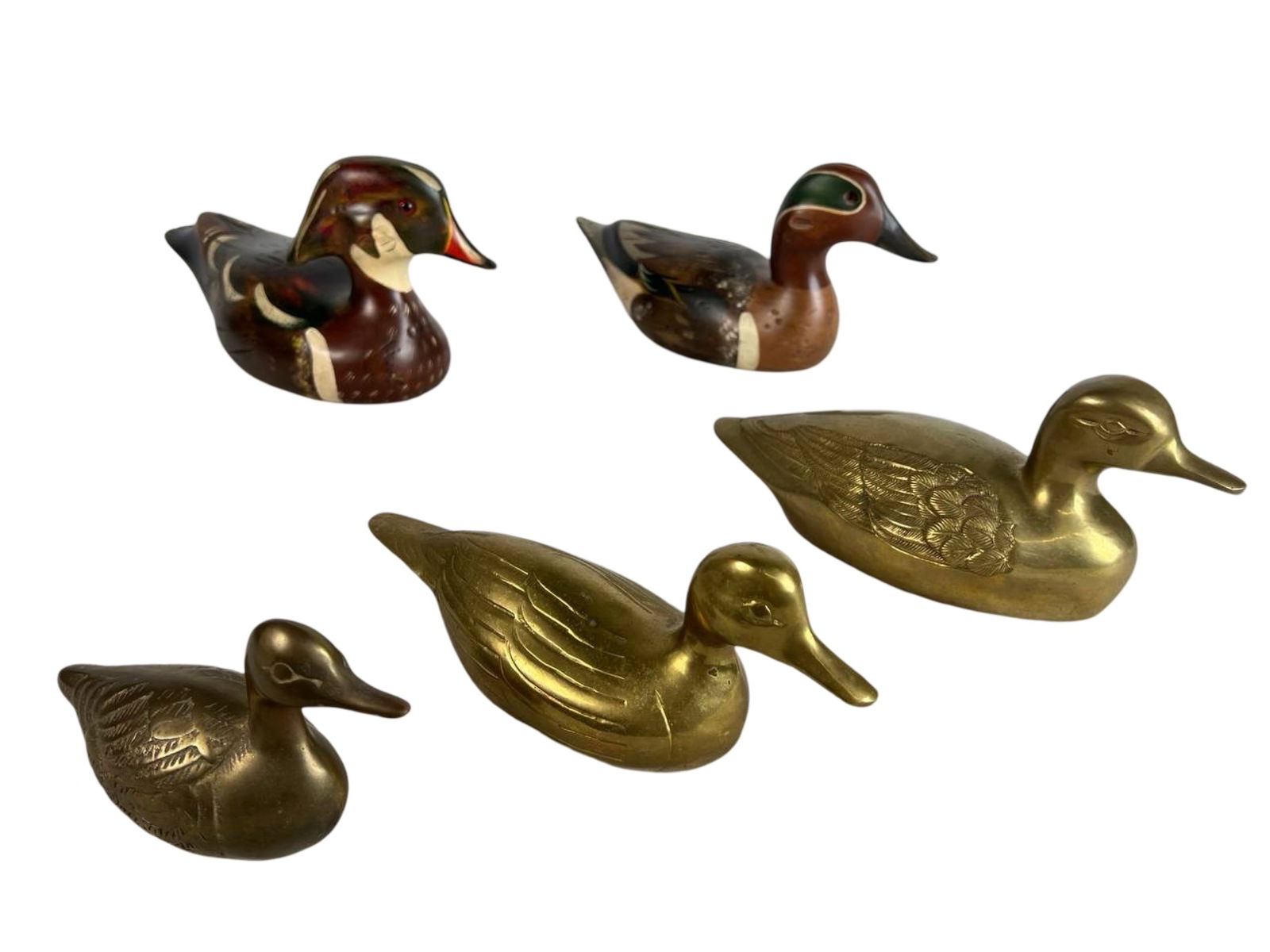Wooden Duck Decoys by Doreline Riesgraf & Brass: This charming set includes two beautifully hand-carved and hand-painted wooden duck decoys signed by artist Doreline Riesgraf and produced by A Wooden Bird Factory in the USA. One represents a Wood Du