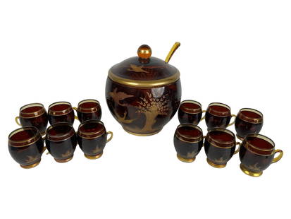 Bohemian Czech Amber & Gold Crystal Punch Bowl Set: Mid-20th century Bohemian Czech crystal punch bowl set made of deep amber glass with hand-engraved and gilded decoration featuring birds and trees. The set includes a large punch bowl with matching li
