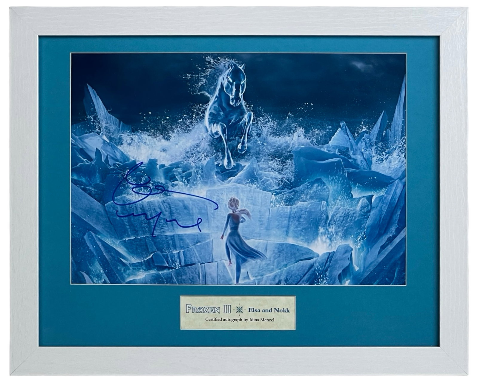 "Frozen II" Idina Menzel Autographed Photograph: Enchanting scene from Frozen II featuring Elsa and the mythical water spirit Nokk, boldly autographed by Idina Menzel, the voice of Elsa. Elegantly custom framed in icy blue tones, this display piece 