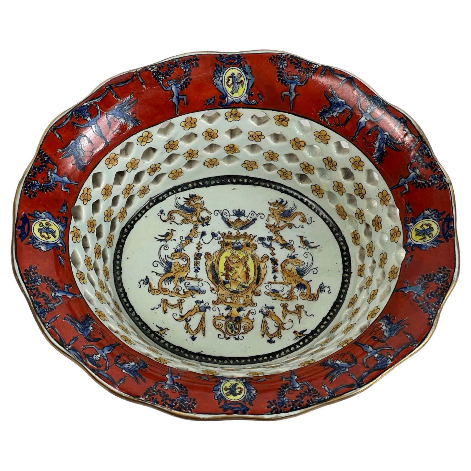 Antique Porcelain Basket - Crest, Cherubs, Mythica: Beautifully crafted antique porcelain fruit or vegetable basket featuring a pierced reticulated body and elaborate hand-painted decoration. The design showcases a regal crest flanked by a lion and uni