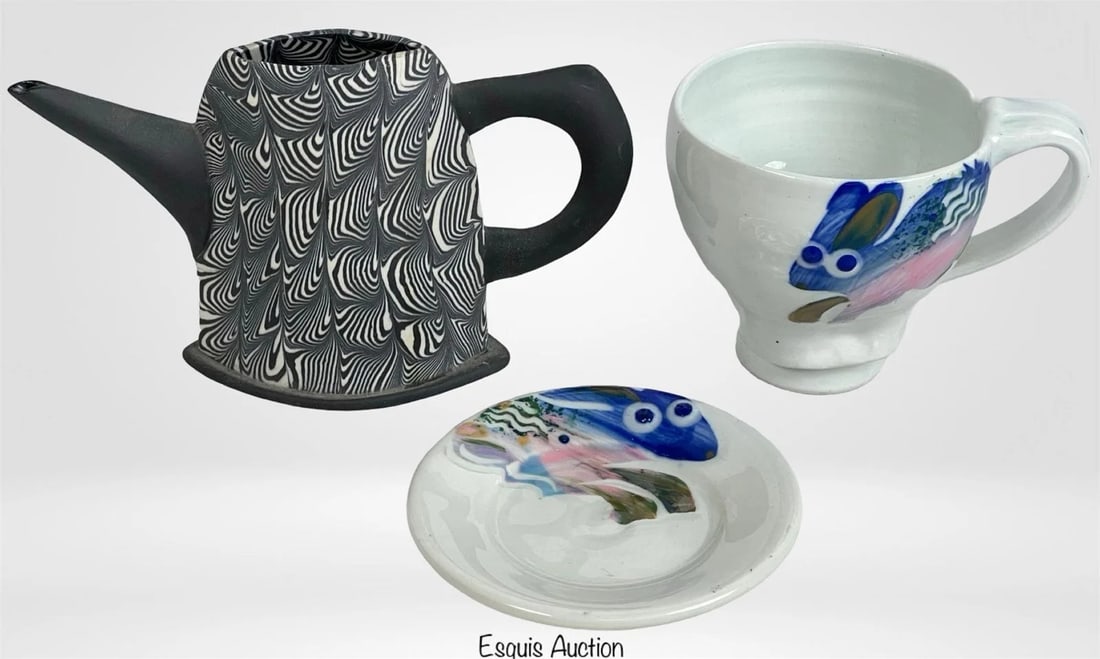 Karen Orsillo Porcelain Teapot Rainbow Rabbit Cup: This lot features a handcrafted porcelain teapot by renowned artist Karen Orsillo, showcasing her signature marbled black-and-white design. The teapot measures approximately 6.5" x 4". Accompanying th