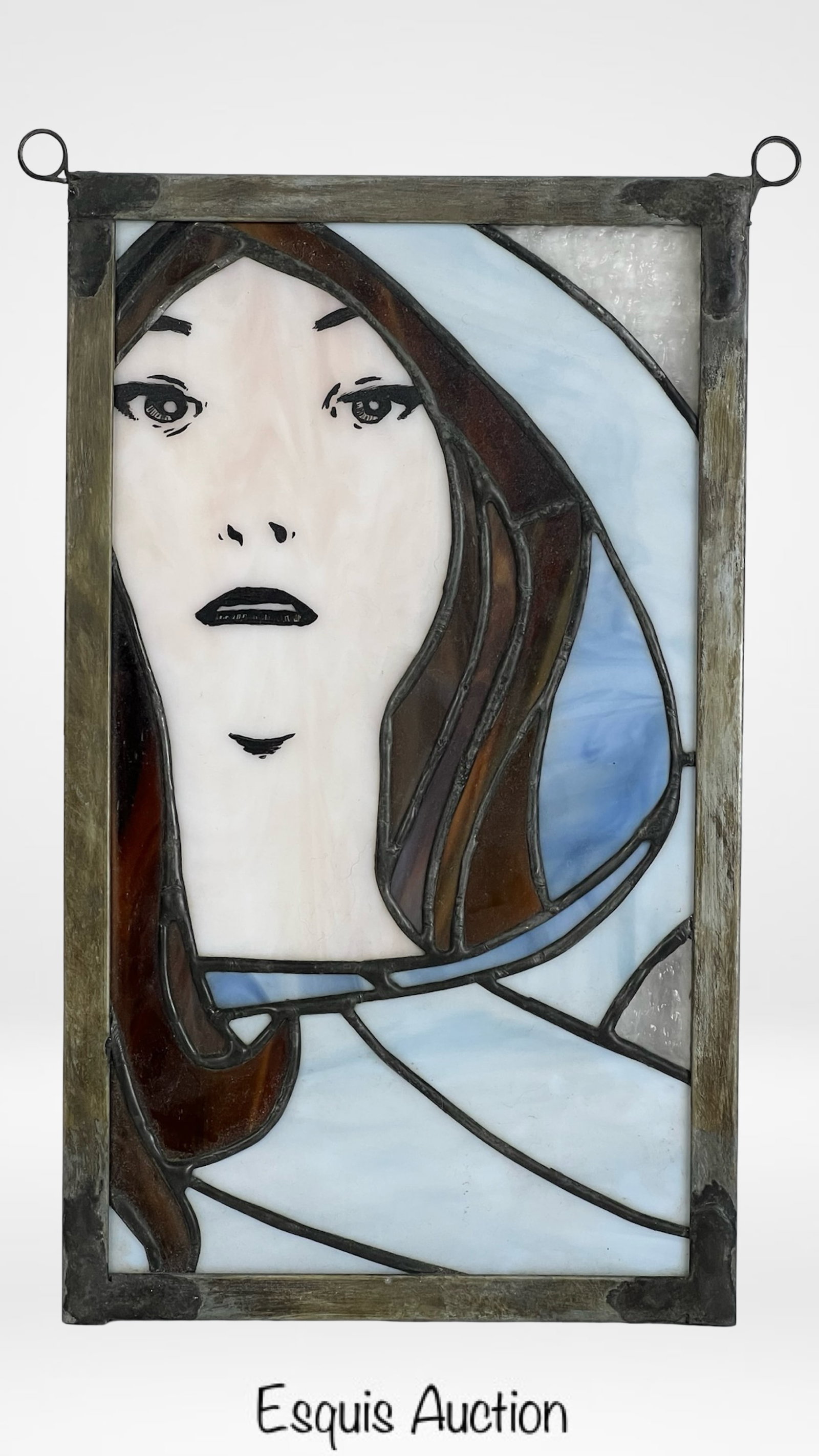 Art Nouveau Style Stained Glass Panel: Elegant Art Nouveau style stained glass panel featuring the serene image of a woman in a flowing hooded robe, rendered in soft tones of blue, white, and amber glass. Measures approximately 12" x 7". G