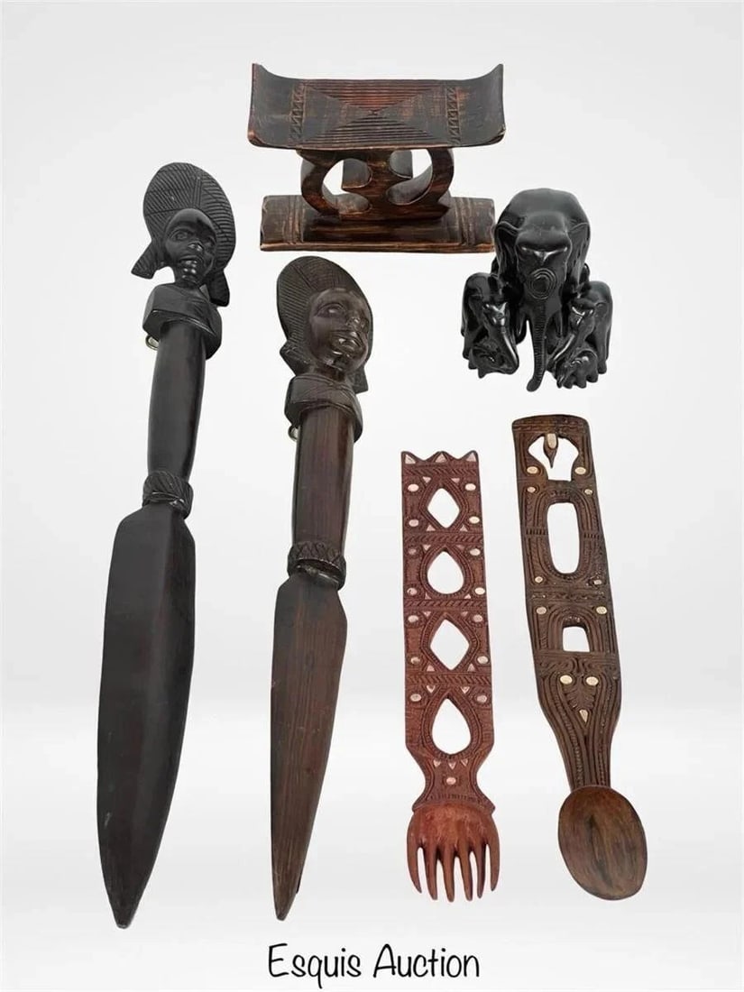 African & Asian Wood Carvings: Group of seven hand-carved wooden tribal artifacts from various world regions, including a pair of Trobriand ceremonial spears with stylized figural finials and geometric patterns; a Thai wood-carved 