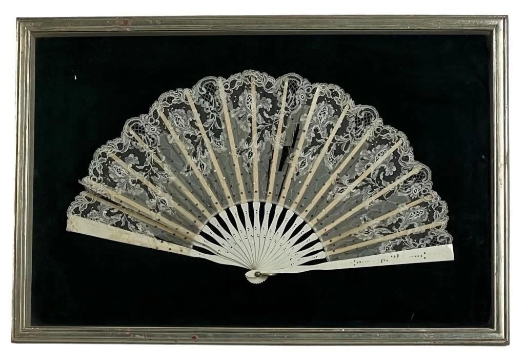 Antique Bone & Lace Lady's Fashion Folding Fan: This exquisite antique folding fan is a fine example of 19th-century craftsmanship, combining delicate lacework with intricately carved bone. The fan is custom framed in a shadow box, preserving its b