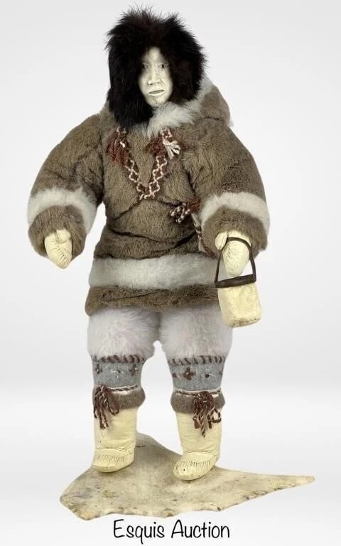 Inuit Caribou Bone Doll - Mikki & Noah Siusangark: Exceptional hand-crafted Inuit doll by renowned artists Mikki and Noah Siusangark, depicting a mother carrying her child and holding a traditional leather fish bucket. Carved with masterful precision,
