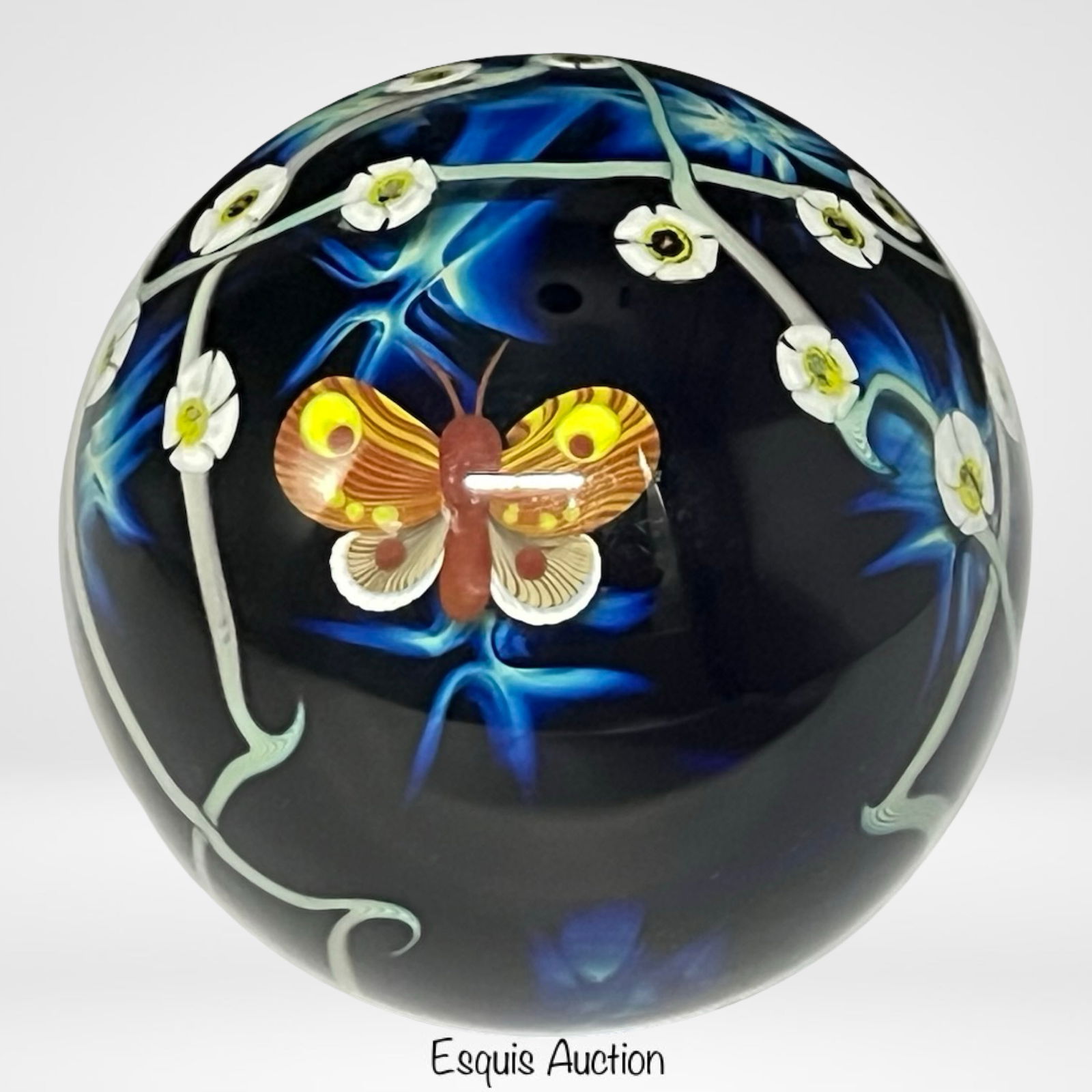 Zelique Studio Art Glass Butterfly Paperweight: Striking and vibrant large studio art glass paperweight by Joseph Morel for Zelique Studio, featuring a beautifully detailed butterfly in flight surrounded by twisting vines and delicate white blossom