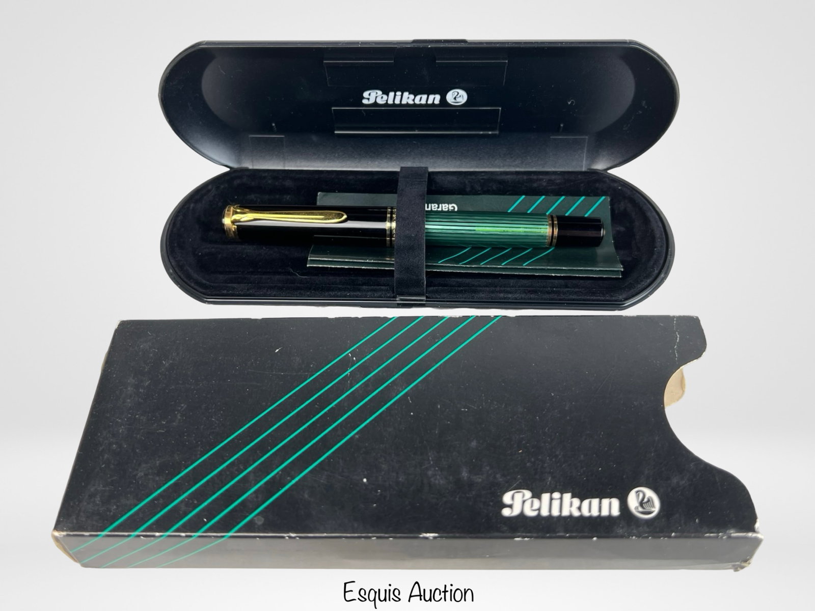 Pelikan Souveran M800 Fountain Pen- 18K Gold Nib: Pelikan Souverän M800 fountain pen featuring the brand's signature green striped resin barrel, black cap, and gold-plated trim. The pen is fitted with a two-tone 18K (750) gold nib, marked with a med