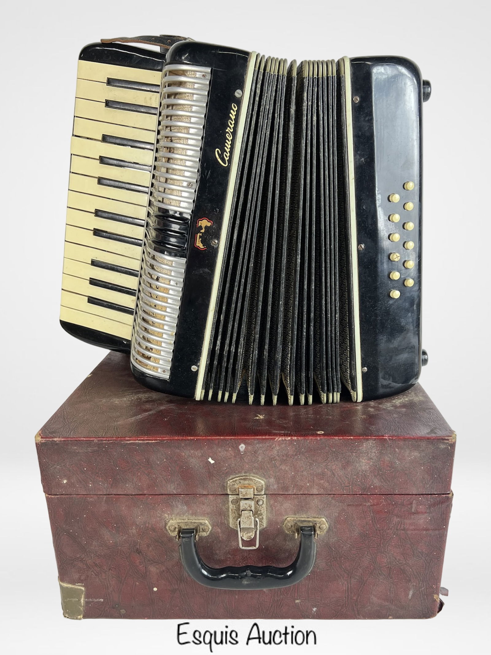 Camerano Vintage Italian Accordion: Classic vintage Camerano accordion, Made in Italy, featuring a black and ivory body with 25 piano keys and 12 bass buttons.Being sold as is- for parts or repair, Pieces are moving inside.