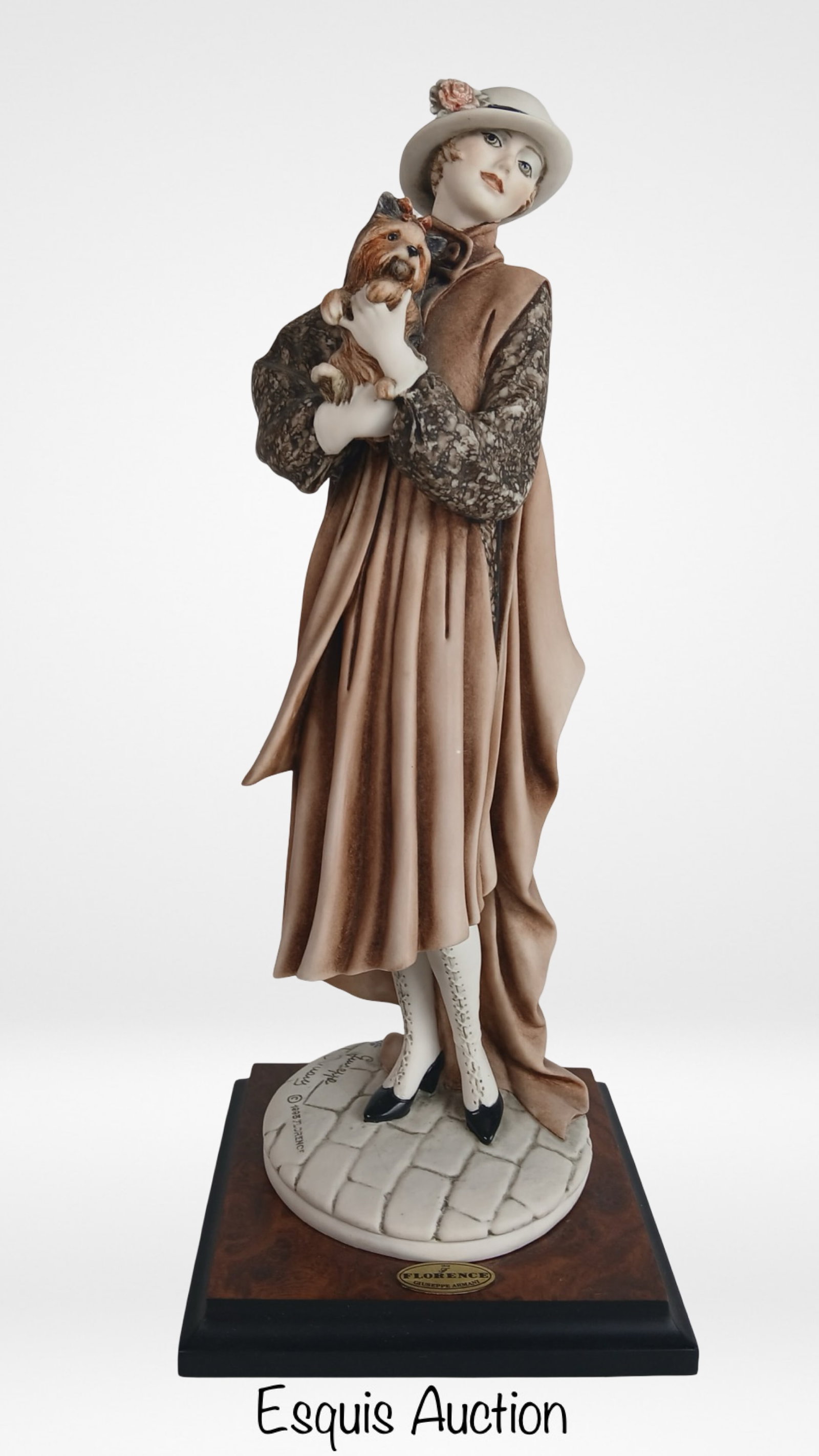 iuseppe Armani Young Lady with Yorkshire Terrier: Charming Giuseppe Armani figurine titled Young Lady with Yorkshire Terrier, model 0486C. This 13-inch tall sculpture portrays an elegantly dressed woman holding a small Yorkshire terrier, beautifully 