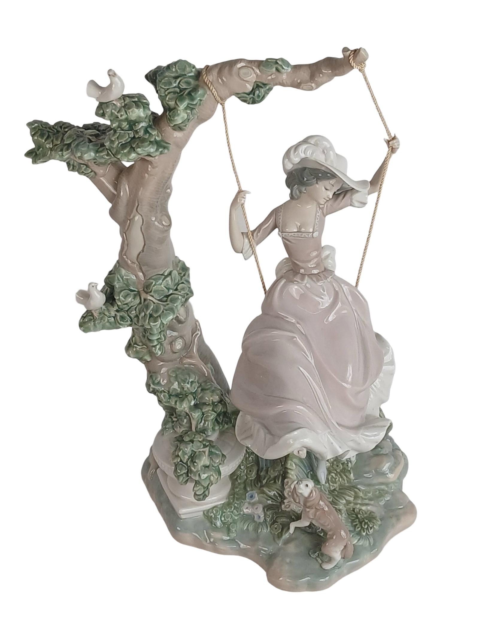 Lladro Porcelain Figurine Victorian Girl on Swing: Charming and intricately detailed Lladro porcelain figurine titled Victorian Girl on Swing, model #1296. This elegant piece depicts a young girl in flowing Victorian dress seated on a swing suspended 