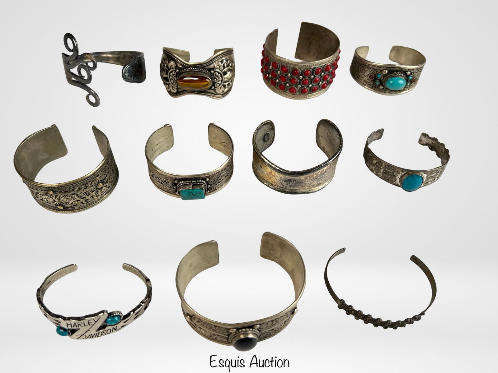 Silver Tone Southwest & Middle Eastern Bracelets: Diverse collection of 13 vintage silver tone cuff bracelets featuring Southwest and Middle Eastern style influences. Designs include filigree, engraved, stamped, and repoussÃ© details, with select p