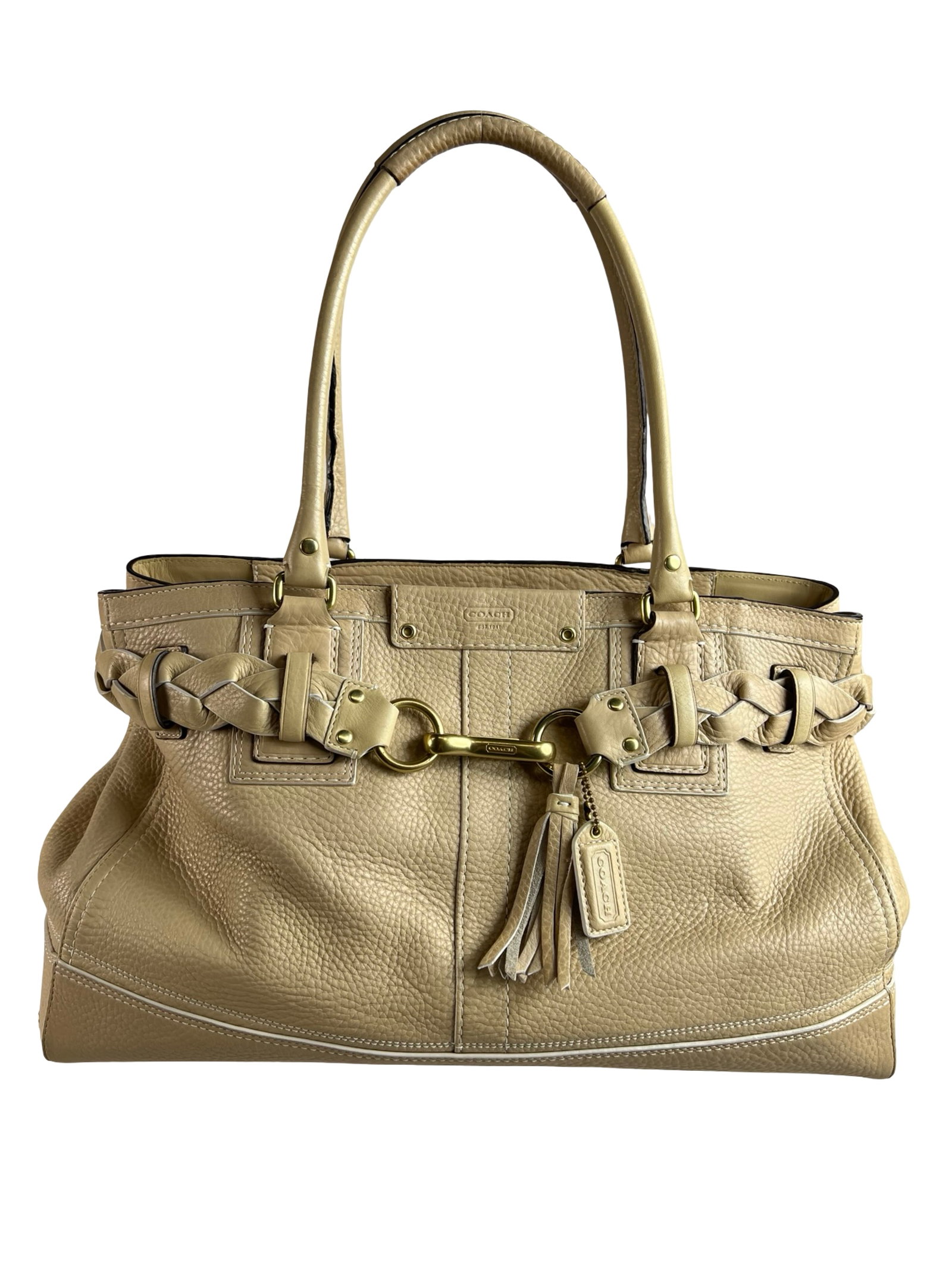 Coach Hampton Beige Pebbled Satchel Handbag: Spacious and sophisticated Coach Hampton satchel in a soft beige tone with braided handle accents and signature hardware detailing. Features include dual top handles, front tassel charm, and ample int