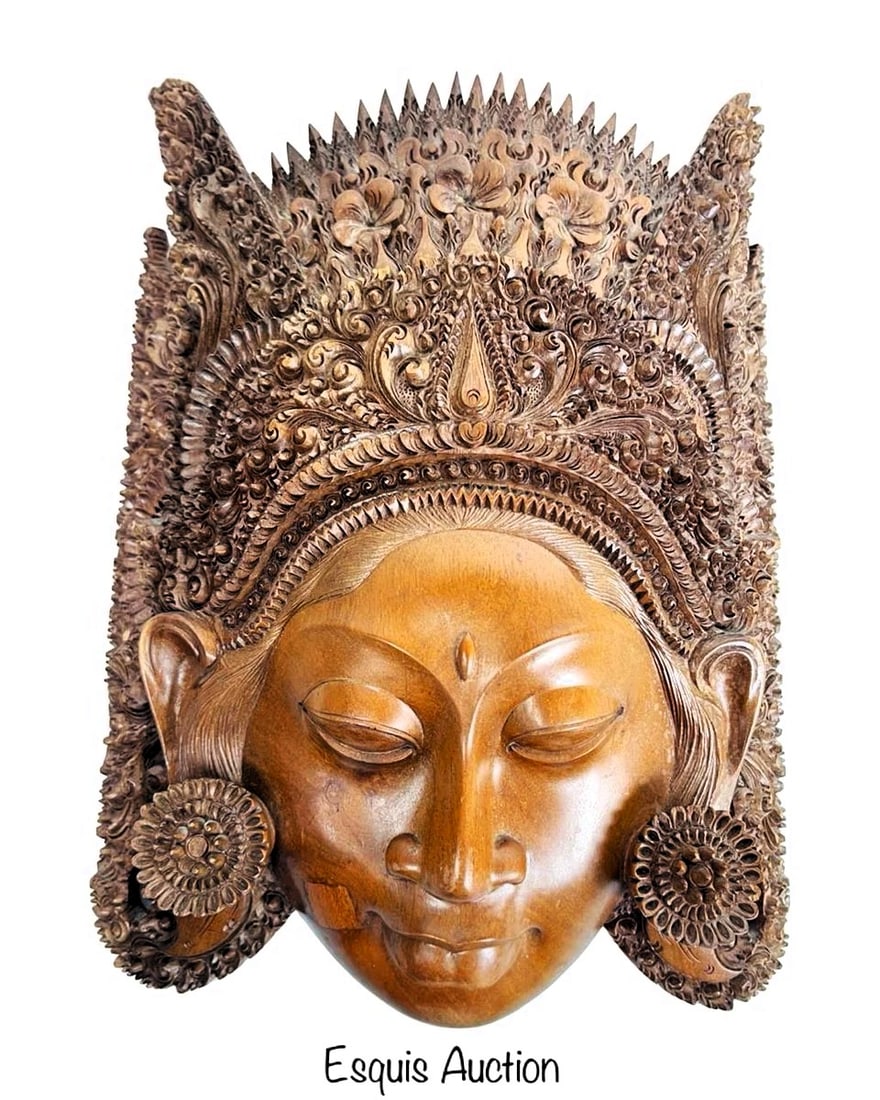 Balinese Hand-Carved Wood Mask of Sita: Beautifully hand-carved Balinese wood mask depicting Sita, the devoted wife of Rama from the Ramayana epic. The mask features an elaborate headdress with intricate floral and scrollwork detailing, sym