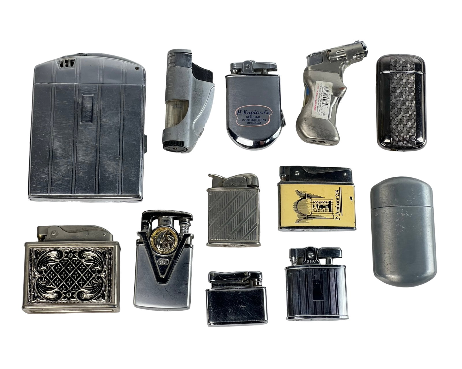 Collection of Vintage & Novelty Pocket Lighters: Eclectic grouping of twelve vintage and mid-century pocket lighters in a variety of styles, including flip-top, butane torch, and novelty forms.