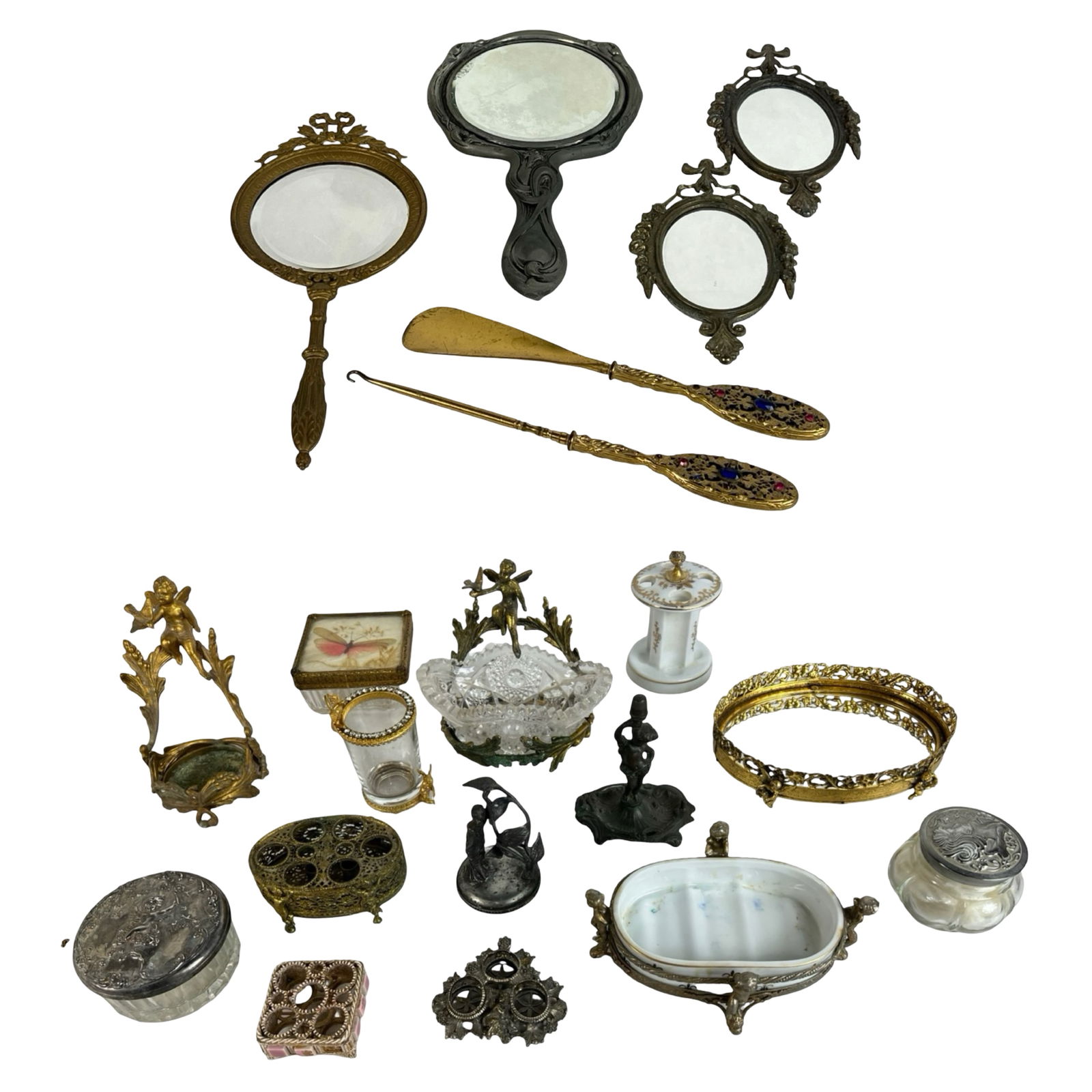 Antique and Vintage Vanity Table Accessories: An exquisite and eclectic assortment of antique and vintage vanity table accessories, showcasing ornate Victorian and Art Nouveau designs. This lot includes a selection of hand mirrors, dresser jars w