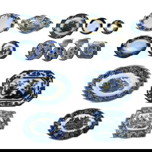 19th-20th C.  Blue and White Transferware China: This extensive 19-piece assortment of antique and vintage blue and white transferware features serving platters, shallow bowls, handled dishes, and decorative plates from the 19th and 20th centuries.