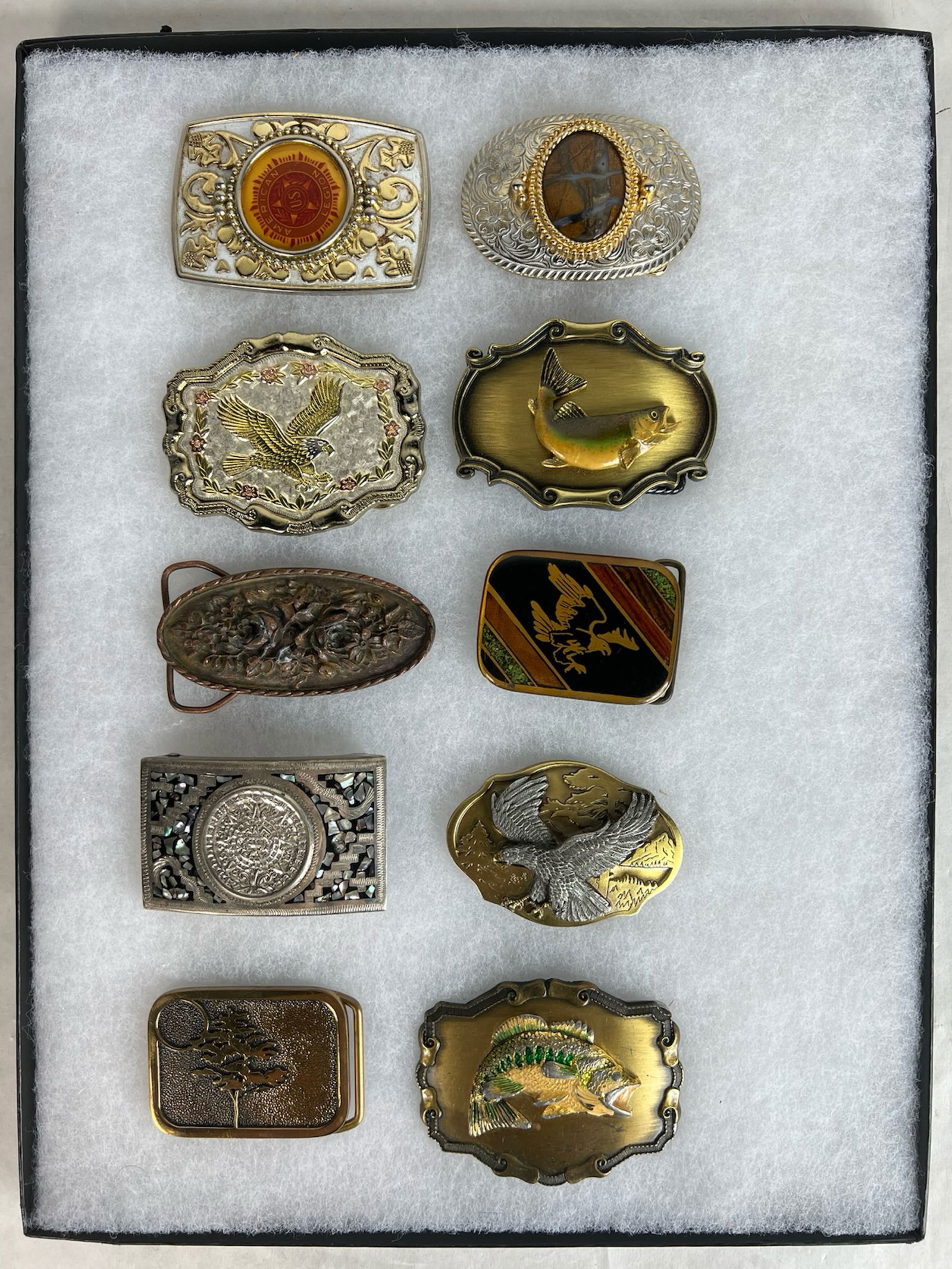 Collection of Vintage & Commemorative Belt Buckles: Eclectic assortment of 10 vintage and commemorative belt buckles, showcasing a range of themes including wildlife, Americana, fishing, and Native motifs. Materials include cast metal, enamel inlay, an