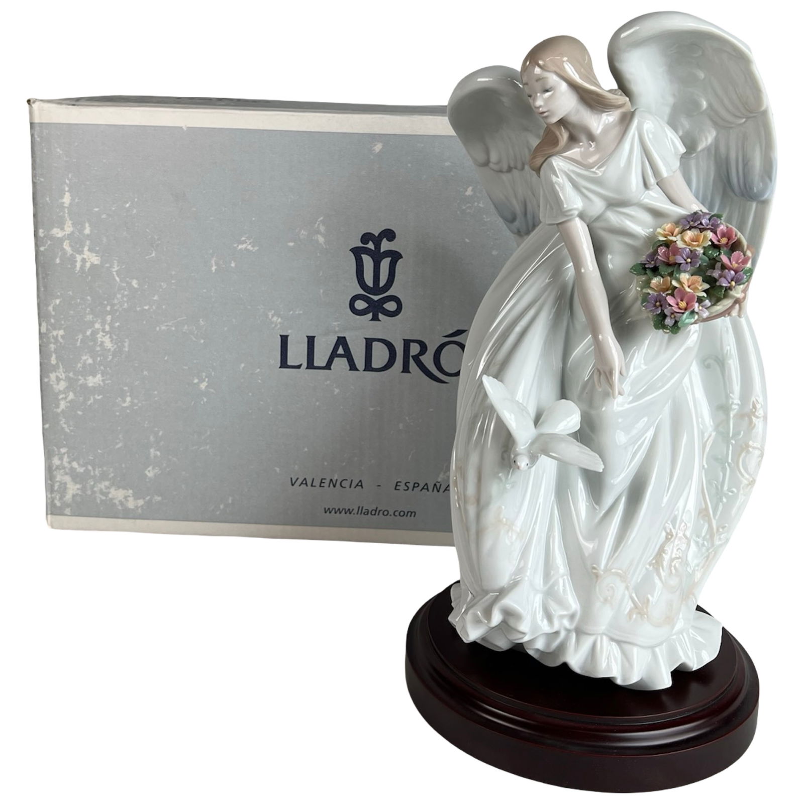 Lladro "Flowers of Peace" LE Porcelain Figurine: Exquisite Lladro porcelain figurine titled Flowers of Peace, model #1867. This serene and graceful sculpture features an angel in flowing robes holding a colorful bouquet as a dove takes flight from h