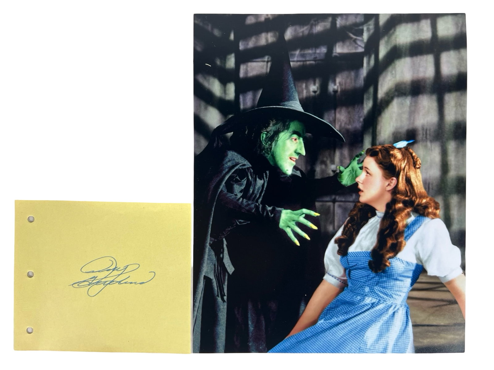 Judy Garland Autograph w/ Wizard of Oz Photo: Capture the magic of "The Wizard of Oz" with this Judy Garland Signature/ Autograph Album Page paired with an iconic photograph. The legendary Judy Garland, known for her unforgettable portrayal of Do