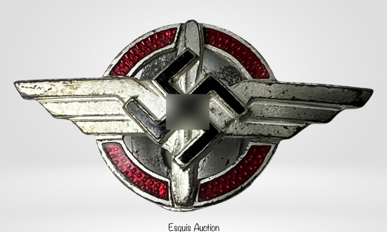 WWII German DLV (Deutsches Luftsport Verband) Pin: WWII-era member lapel pin from the Deutsches Luftsport Verband (German Air Sports Association), a pre-war aviation organization. The design features stylized wings over a red enameled background, mark