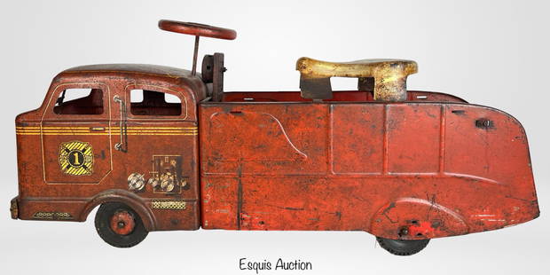 1950s Pressed Steel Marx Sit-N-Ride Fire Truck Toy: Charming and well-loved example of mid-century American toy design, this vintage 1950s pressed steel Sit-N-Ride fire truck by Louis Marx & Co. features lithographed detailing, a molded metal steering