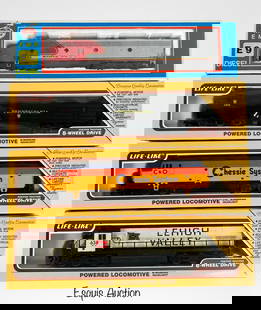 Model Power & Life-Like HO Scale Train Locomotives: Group of four HO scale powered locomotives in mint condition, each preserved in its original box. Includes a Model Power EMD E9 Diesel locomotive in Santa Fe livery (No. 920), along with three Life-Li