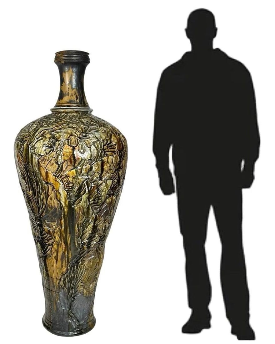 Monumental Glazed Majolica Floor Vase Floral Motif: This extraordinary floor vase is a true statement piece, standing an impressive 53 inches tall with a 22-inch diameter. Handcrafted in glazed majolica, the vase features a breathtakingly detailed reli