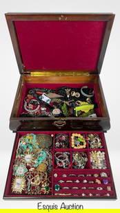 Large Jewelry Chest Overflowing with Treasures: Impressive vintage wooden jewelry chest filled with a wide variety of unsearched costume jewelry and assorted trinkets. The chest features a deep red velvet interior with an upper compartment and a re